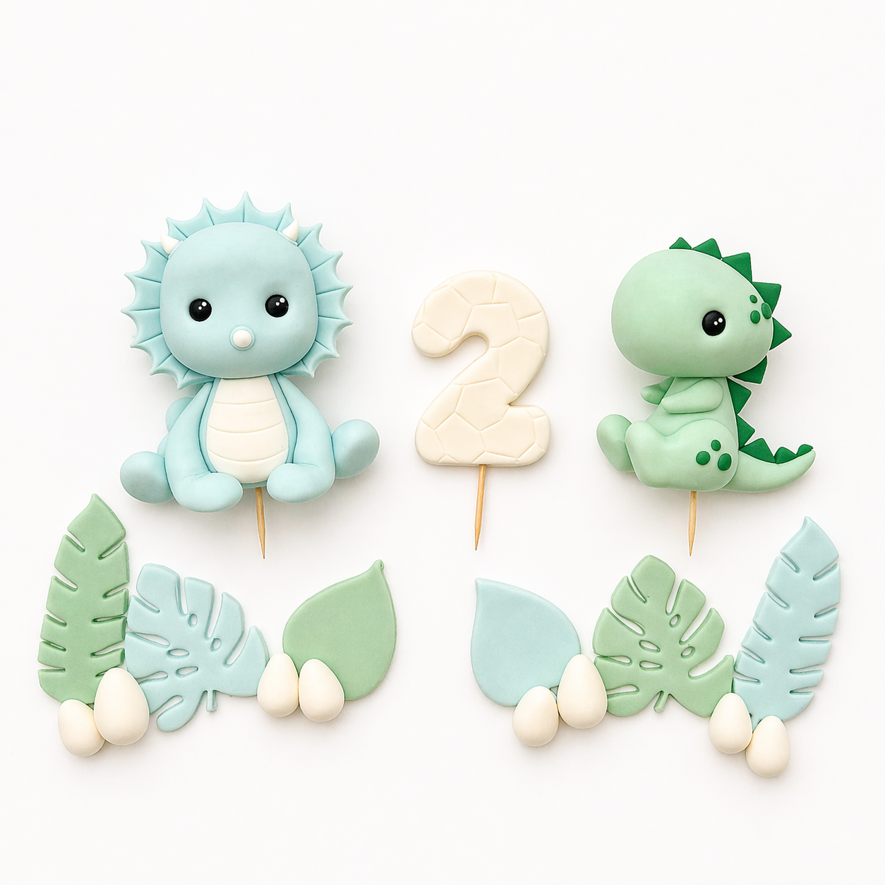 Set of dinosaur-themed cake toppers with leaves on a white background
